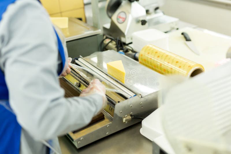 Package of Cheese Wrapped in Plastic in the Supermarket Stock Image