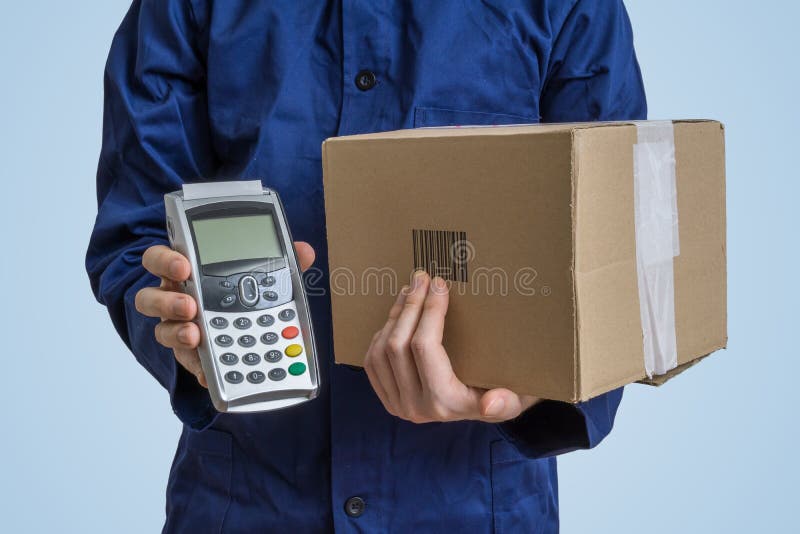Package delivery concept. Man holds cardboard box and payment terminal. royalty free stock photos