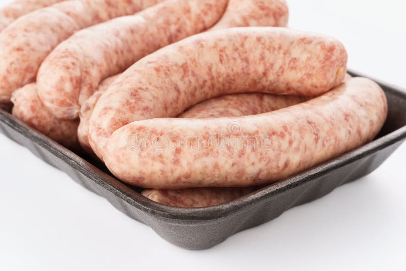 Package of Raw Beef or Pork Sausages on White Background Stock Photo