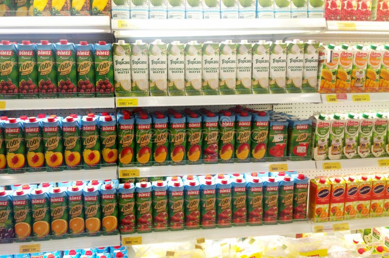 Packed and bottle of juice drink display on refrigerated rack in supermarkets.