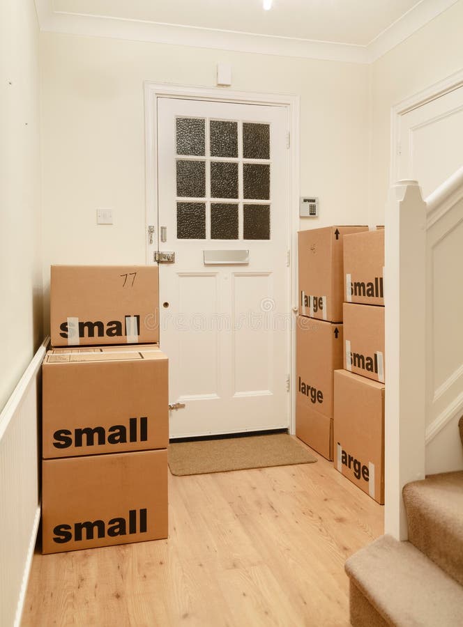 Packing boxes, cardboard boxes for moving house, UK. Packed and taped cardboard boxes stacked inside a room of a home, moving house, UK royalty free stock photography Packing boxes, cardboard boxes for moving house, UK. Packed and taped cardboard boxes stacked inside a room of a home, moving house, UK royalty free stock photography