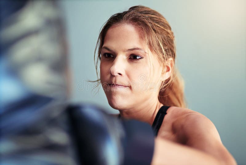 She Packs Quite A Punch A Female Boxer Working Out With A Punching Bag