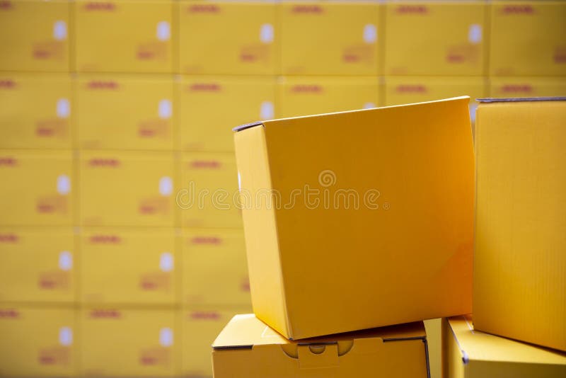 Yellow transportation boxes packages are seen arranged in a warehouse. Yellow transportation boxes packages are seen arranged in a warehouse
