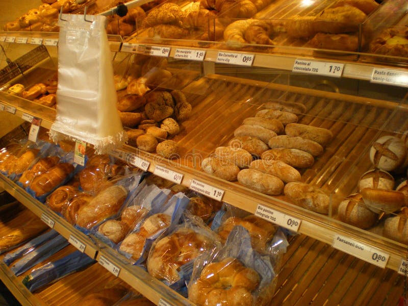 An Italian bread shop with shelves of all kinds of bread and pastries and croissants on display in Italy. An Italian bread shop with shelves of all kinds of bread and pastries and croissants on display in Italy