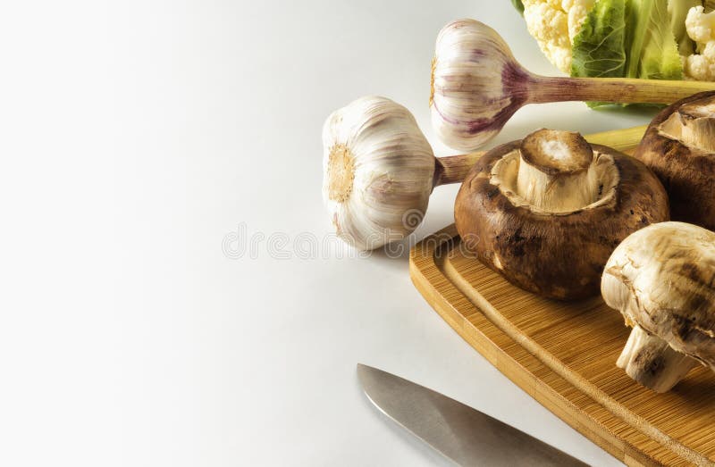 Paddestoelen en knoflook op een scherpe Raad royalty-vrije stock afbeeldingen Paddestoelen en knoflook op een scherpe Raad royalty-vrije stock afbeeldingen