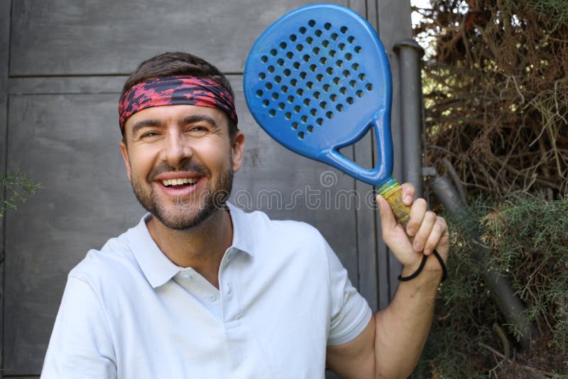 Beautiful Female Tennis Player Wearing A Headband Holding Her