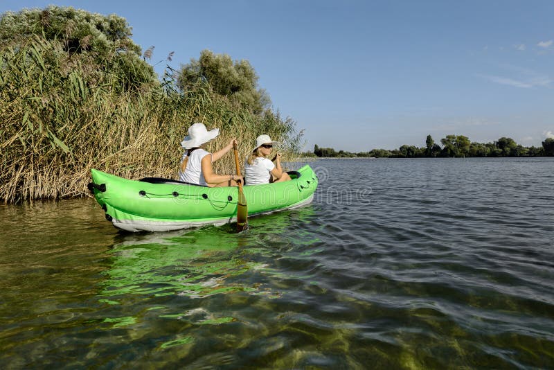 Paddling with Inflatable Canoe Kayak Boat at River Lake Stock Photo