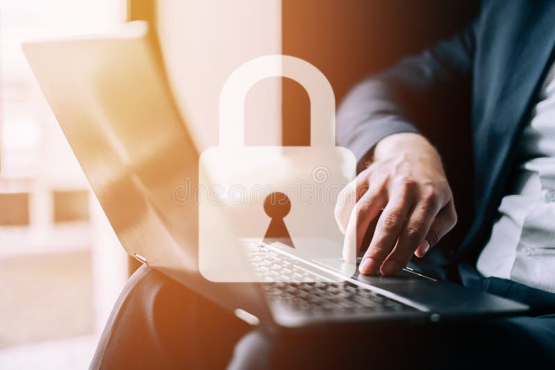 Padlock on the background of a man working on a laptop