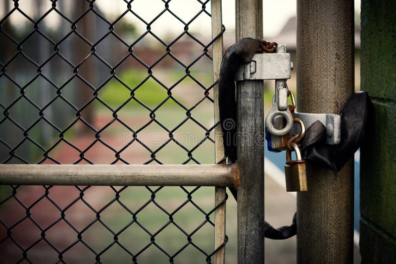 Padlock on a Chain-link Gate stock photos.
