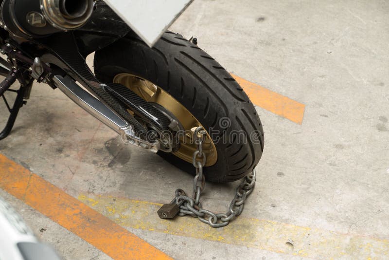 Padlock Security Lock Blocking The Motorcycle Wheel On Street, A Stock
