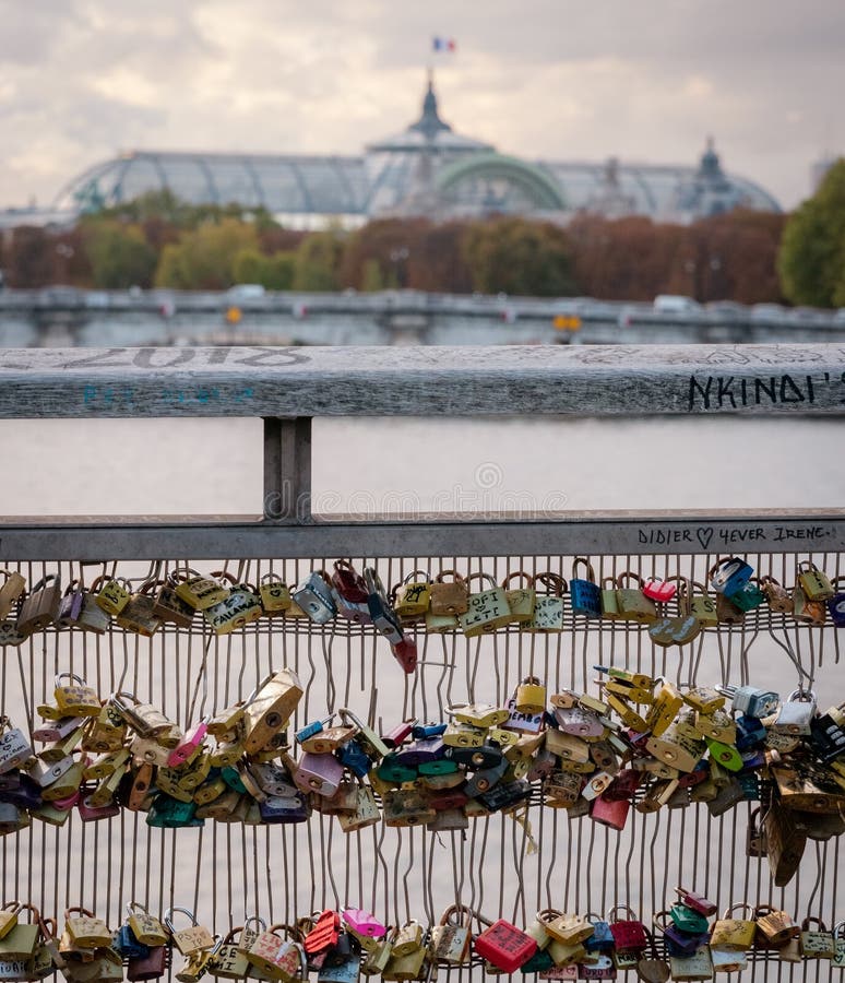 PADLOCKS on a PARIS BRIDGE with the SEVEN in the BACKGROUND and the