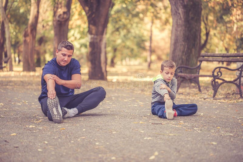 Padre e figlio che si esercitano insieme all'aperto fotografia stock Padre e figlio che si esercitano insieme all'aperto fotografia stock