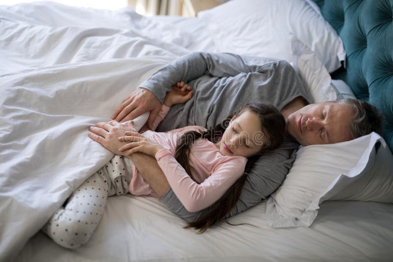 Padre E Hija Que Duermen Junto En Cama En Dormitorio Imagen De Archivo Imagen De Cerrado Lazo