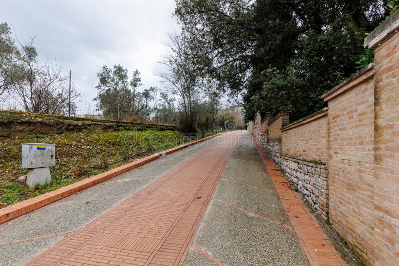 Assisi, Italy - January 1, 2024: Padre Ludovico da Casoria Path leading pilgrims to the Sanctuary of Saint Francis of Assisi on a winter day. Assisi, Italy - January 1, 2024: Padre Ludovico da Casoria Path leading pilgrims to the Sanctuary of Saint Francis of Assisi on a winter day