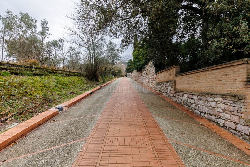 Assisi, Italy - January 1, 2024: Padre Ludovico da Casoria Path leading pilgrims to the Sanctuary of Saint Francis of Assisi on a winter day. Assisi, Italy - January 1, 2024: Padre Ludovico da Casoria Path leading pilgrims to the Sanctuary of Saint Francis of Assisi on a winter day