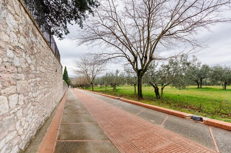 Assisi, Italy - January 1, 2024: Padre Ludovico da Casoria Path leading pilgrims to the Sanctuary of Saint Francis of Assisi on a winter day. Assisi, Italy - January 1, 2024: Padre Ludovico da Casoria Path leading pilgrims to the Sanctuary of Saint Francis of Assisi on a winter day