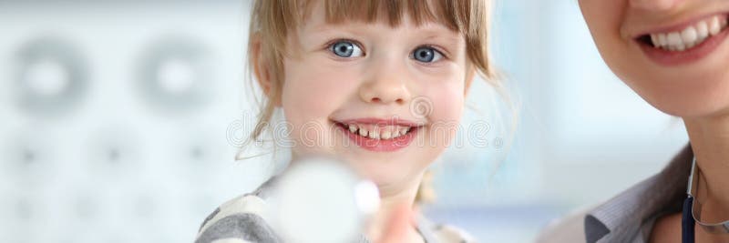 Paediatric doctor holding and hugging little cute girl patient stock image Paediatric doctor holding and hugging little cute girl patient stock image