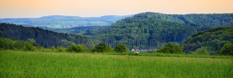 Landscape with a forests and hillocks, at the front village Honzrath in the distance village Dueppenweiler, evening, spring, Saarland/Germany, panoramic. Landscape with a forests and hillocks, at the front village Honzrath in the distance village Dueppenweiler, evening, spring, Saarland/Germany, panoramic