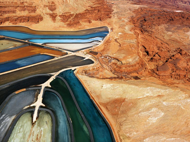 Aerial view of an arid, craggy landscape surrounding tailing ponds. Horizontal shot. Aerial view of an arid, craggy landscape surrounding tailing ponds. Horizontal shot.