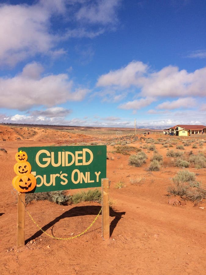 Page, AZ, USA - October 25, 2016: `Guided tours only`-sign at Lower Antelope Canyon near Page, Arizona with pumpkins. Page, AZ, USA - October 25, 2016: `Guided tours only`-sign at Lower Antelope Canyon near Page, Arizona with pumpkins