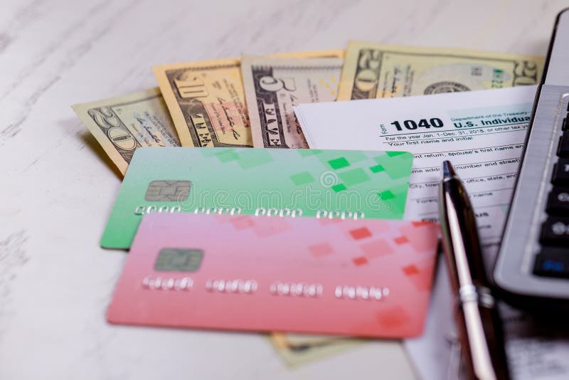 Pague o formulário de imposto 1040 dos EUA do conceito do imposto com notas de dólar dos E.U. e para April Calendar imagens de stock royalty free Pague o formulário de imposto 1040 dos EUA do conceito do imposto com notas de dólar dos E.U. e para April Calendar imagens de stock royalty free