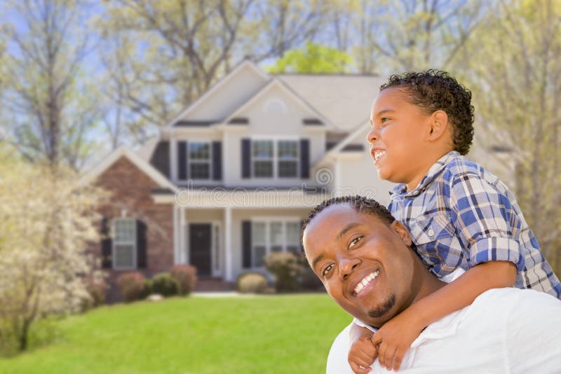 Happy Playful African American Father and Mixed Race Son In Front of House. Happy Playful African American Father and Mixed Race Son In Front of House.