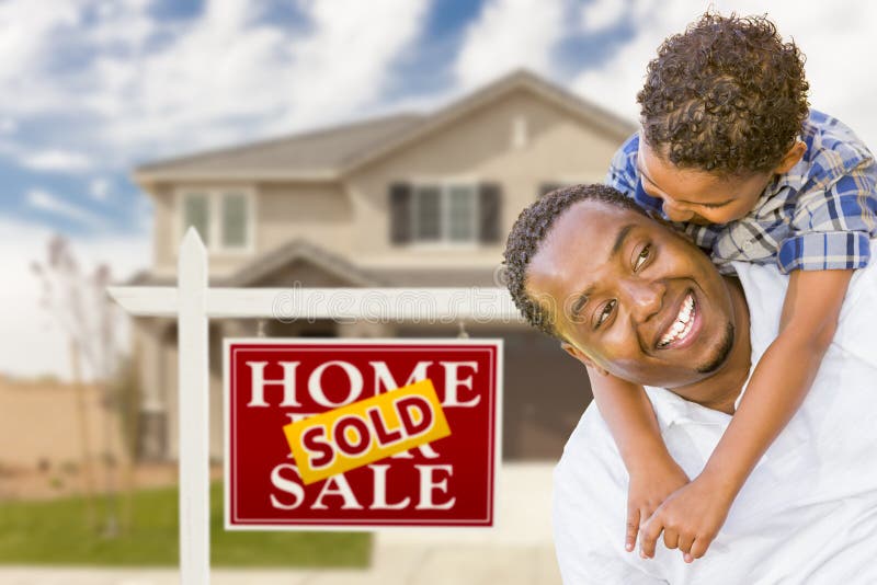 Happy Mixed Race Father and Son In Front of Sold Real Estate Sign and New House. Happy Mixed Race Father and Son In Front of Sold Real Estate Sign and New House.