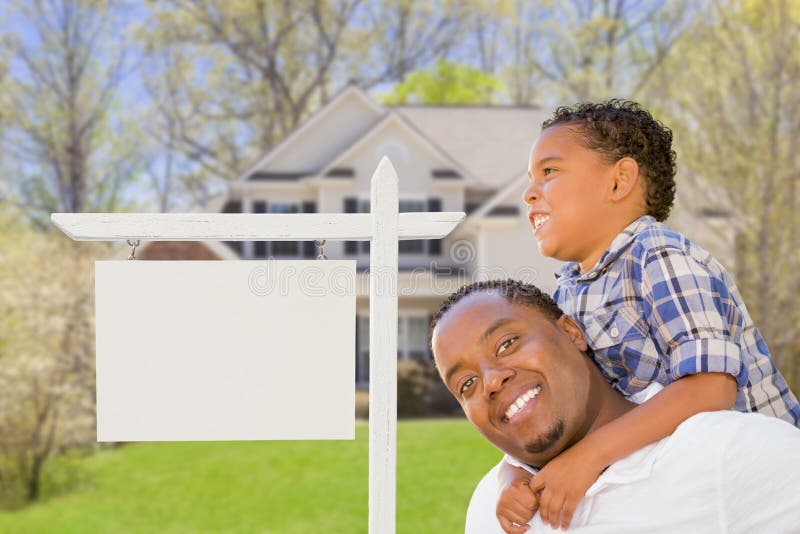 Happy African American Father and Mixed Race Son In Front of Blank Real Estate Sign and New House. Happy African American Father and Mixed Race Son In Front of Blank Real Estate Sign and New House.