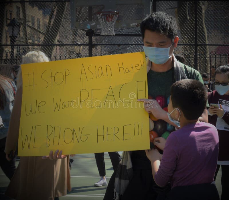 Father and Son Holding `Stop Asian Hate` Sign in Chinatown New York City Protest Against Anti Asian Hate Crimes. Father and Son Holding `Stop Asian Hate` Sign in Chinatown New York City Protest Against Anti Asian Hate Crimes