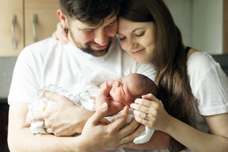 Father and mother with a newborn son. New multi-generation young family. Father and mother with a newborn son. New multi-generation young family.