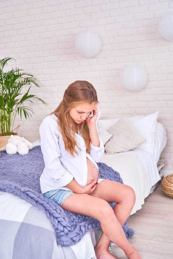 Pain in the abdomen of a pregnant woman, birth pangs before birth. it is difficult for a pregnant woman to sit down and get up royalty free stock photo Pain in the abdomen of a pregnant woman, birth pangs before birth. it is difficult for a pregnant woman to sit down and get up royalty free stock photo