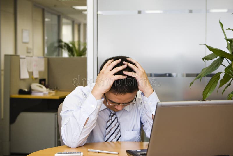 Young asian businessman facing difficult situation in work. Young asian businessman facing difficult situation in work.