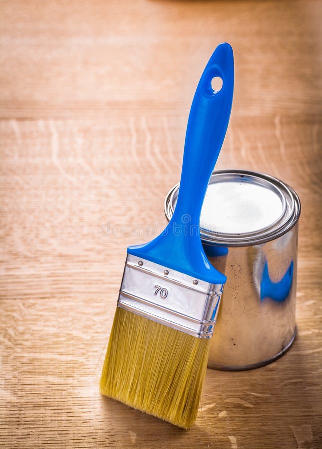Paint Brush with Blue Handle Standing Near Can on Stock Photo Image