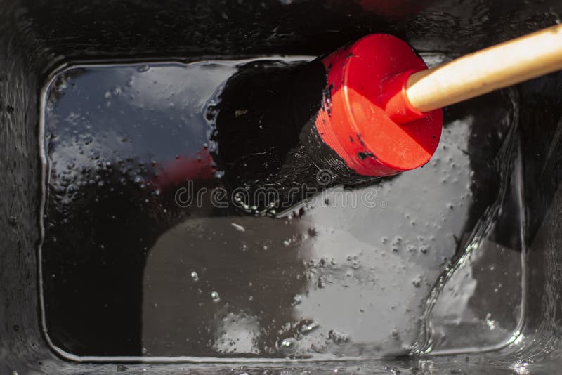 Paint Brush in a Bucket. Black Paint for Wood. Brush in a Thick Layer