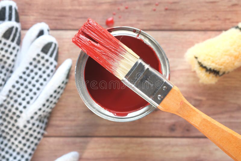 Top View of a Paint Brush , Gloves and Paint on Table Stock Image