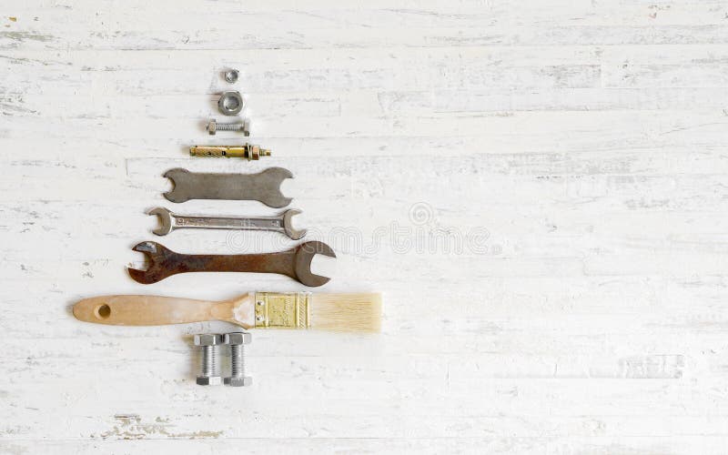 Paint brush wrench, nuts and bolts decorated as christmas tree o royalty free stock photos Paint brush wrench, nuts and bolts decorated as christmas tree o royalty free stock photos