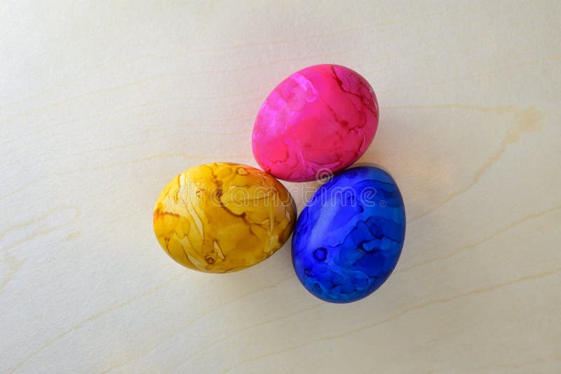 Paint Colored Easter Eggs on Wood Structure Background. View from Above