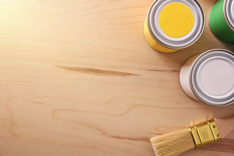 Paint Pots and Brush on Wooden Table with Light Effect Stock Photo