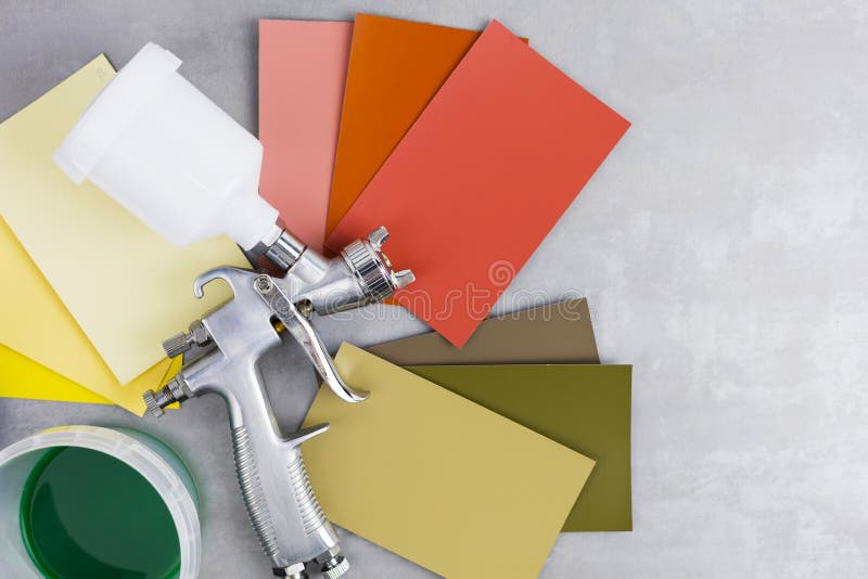 Paint Spray Gun at Work at the Workplace in the Stock Photo
