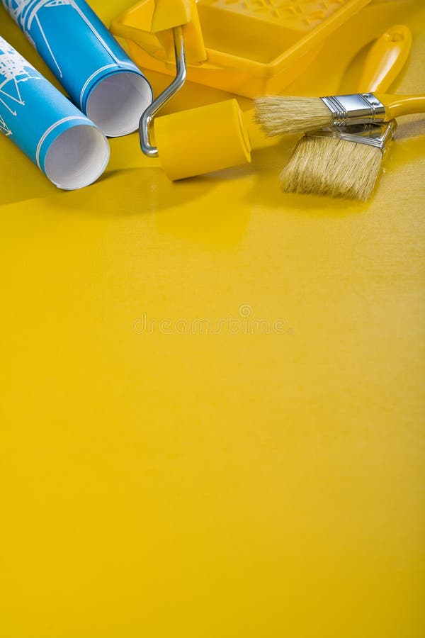 Paint tools on yellow background with copyspace royalty free stock photo