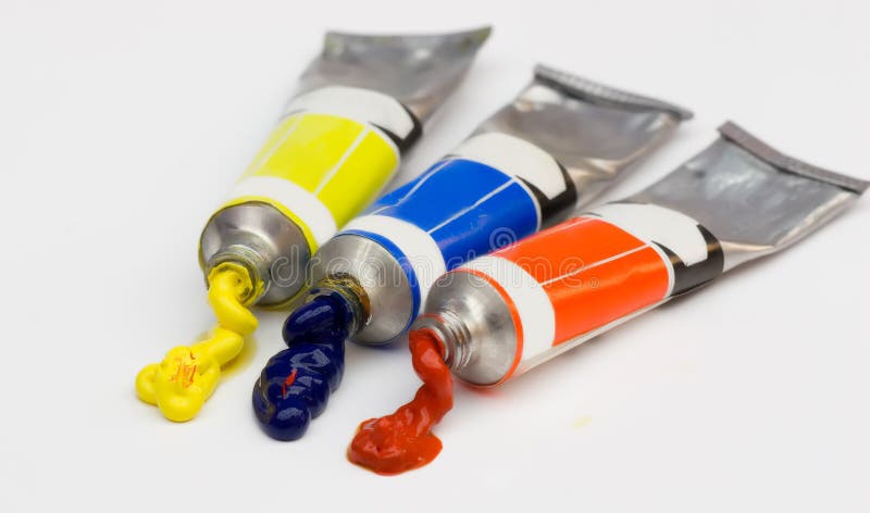 Oil paint spilling from a tube , isolated , with bright colors. Oil paint spilling from a tube , isolated , with bright colors