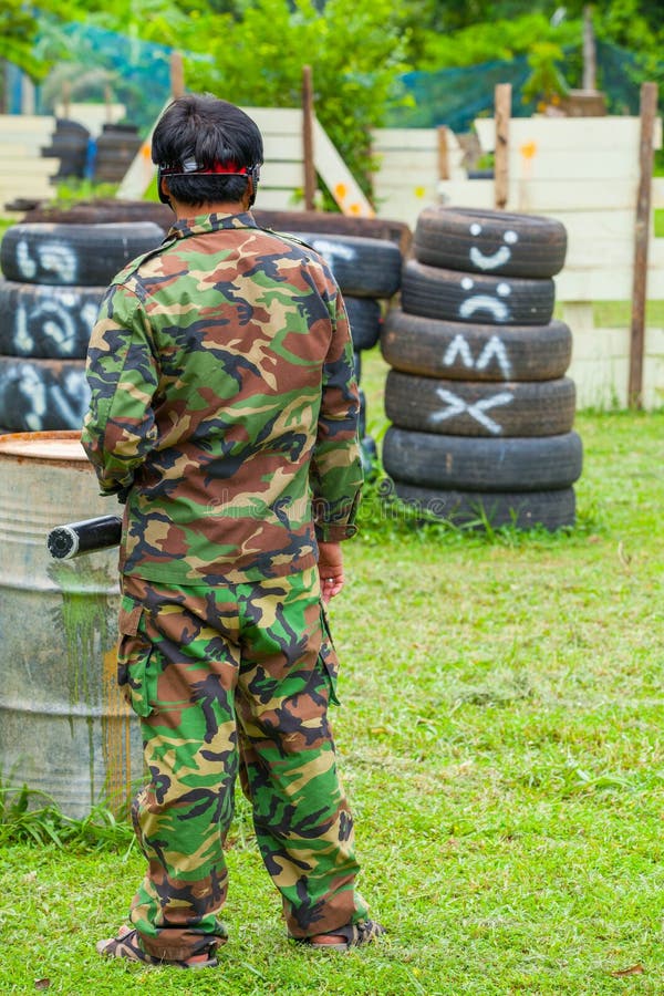 Paintball Sport Player in Protective Uniform and Mask Playing Wi
