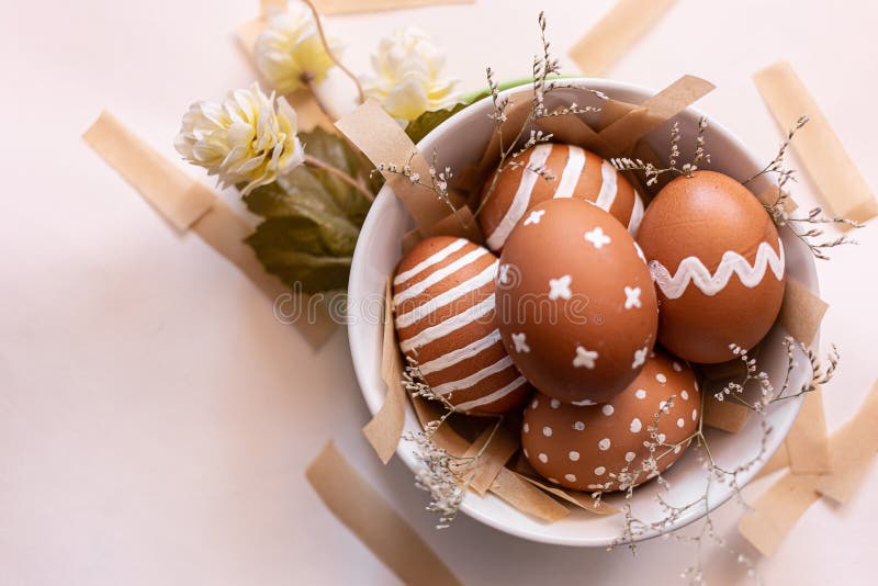 Painted Brown Eggs with Various White Patterns for Easter Holiday in