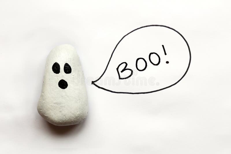 A cartoon painted Halloween Ghost rock is on a white background with a speech bubble that says boo. A cartoon painted Halloween Ghost rock is on a white background with a speech bubble that says boo.