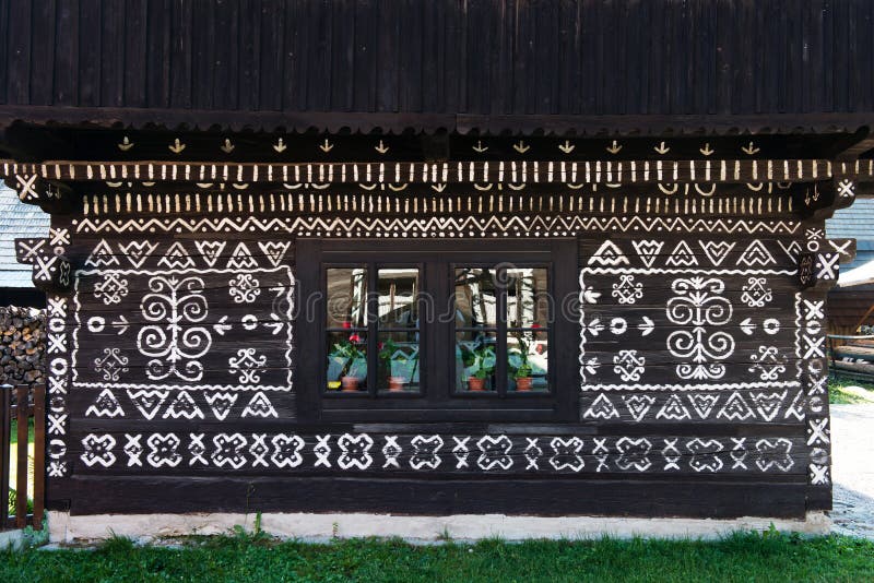 Painted decorations on wall of log house in Cicmany, Slovakia