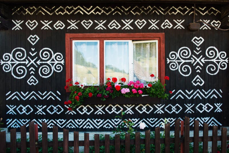 Painted decorations on wall of log house in Cicmany, Slovakia