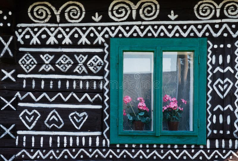 Painted decorations on wall of log house in Cicmany, Slovakia