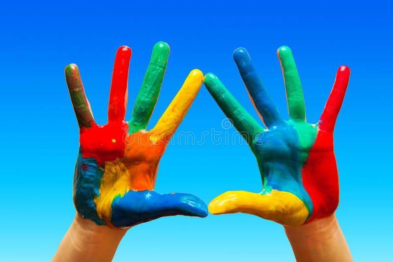 Painted hands, colorful fun. blue sky