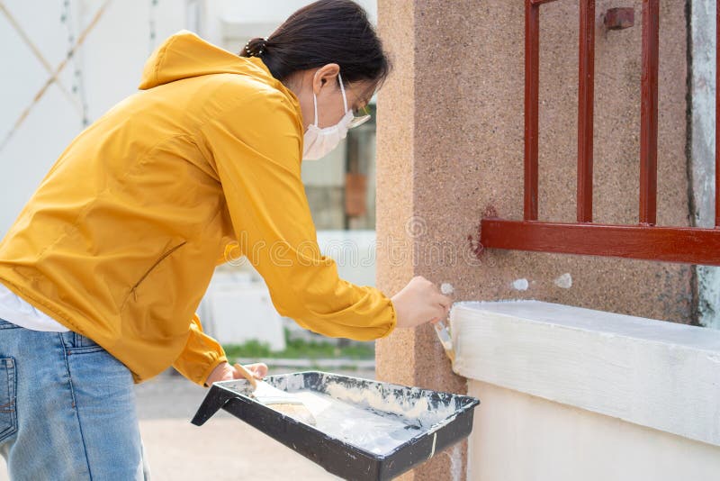 Painter Labor Paint the Wall Using Paint Plots and Rollers. Concepts of