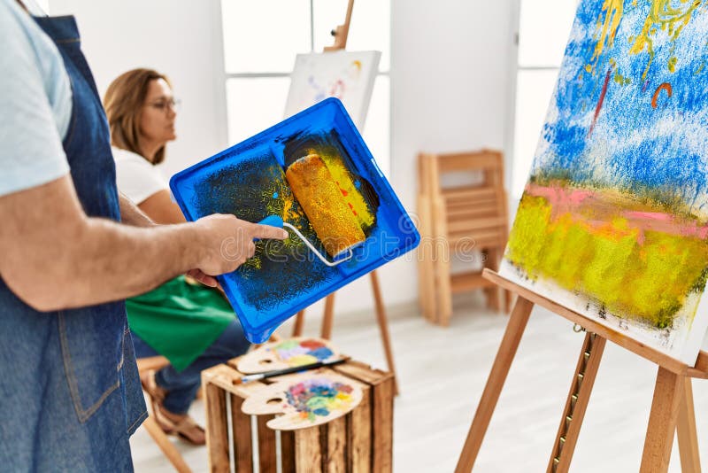 Painter Man Painting Using Paint Roller at Art Studio Stock Image